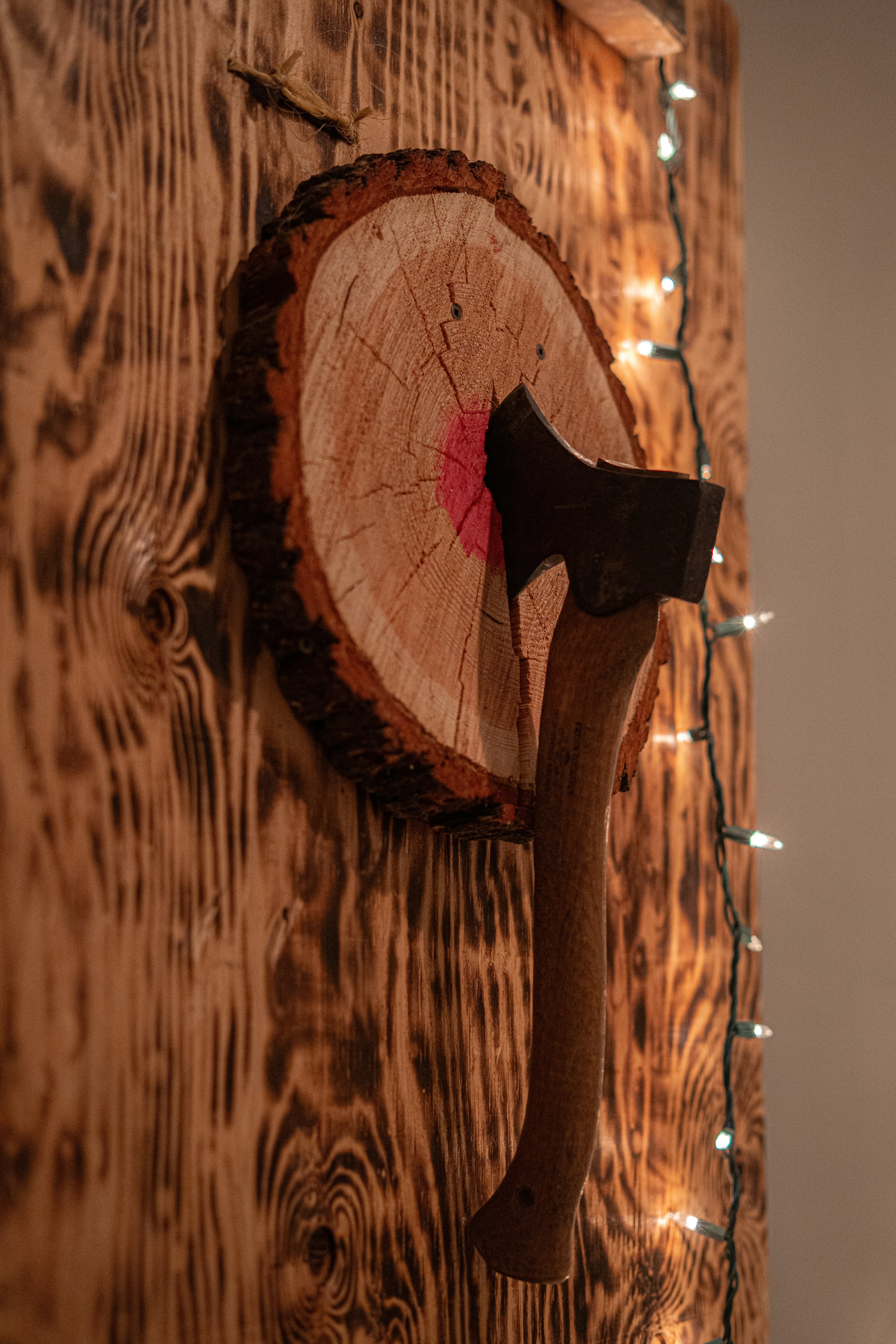 Illustration of an axe in a wooden target; not the venue