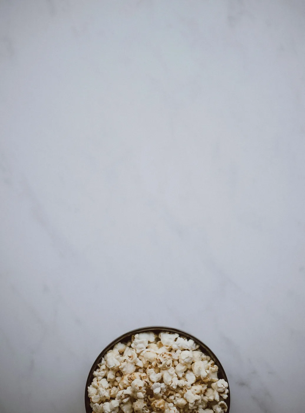 A bowl of popcorn on a white surface; contextual photograph, not a photograph of A Nightmare on Franklin Street film series