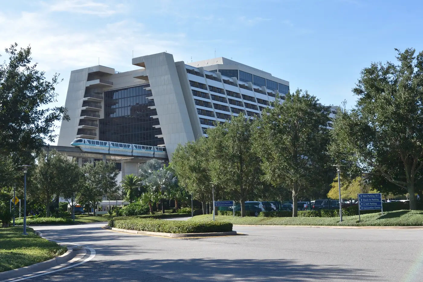 Disney's Contemporary Resort's A-frame tower with a teal monorail train passing through the building's interior atrium