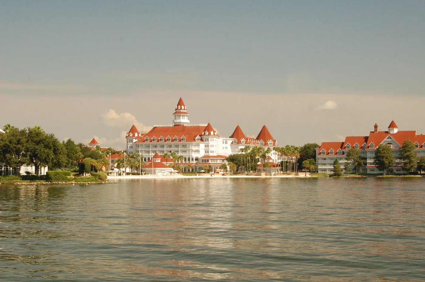 Disney's Grand Floridian Resort's white Victorian buildings and red roofs beside Seven Seas Lagoon