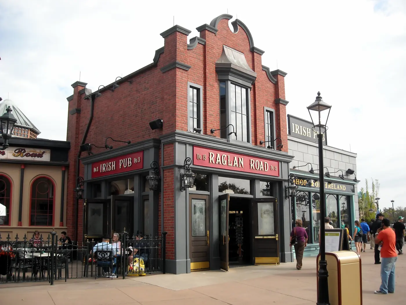 The red-brick exterior of Raglan Road Irish Pub & Restaurant at Disney Springs, with Irish Pub signage and outdoor seating