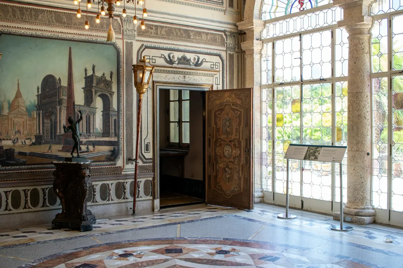 Decorated interior, stone columns and tall windows at Vizcaya Museum and Gardens