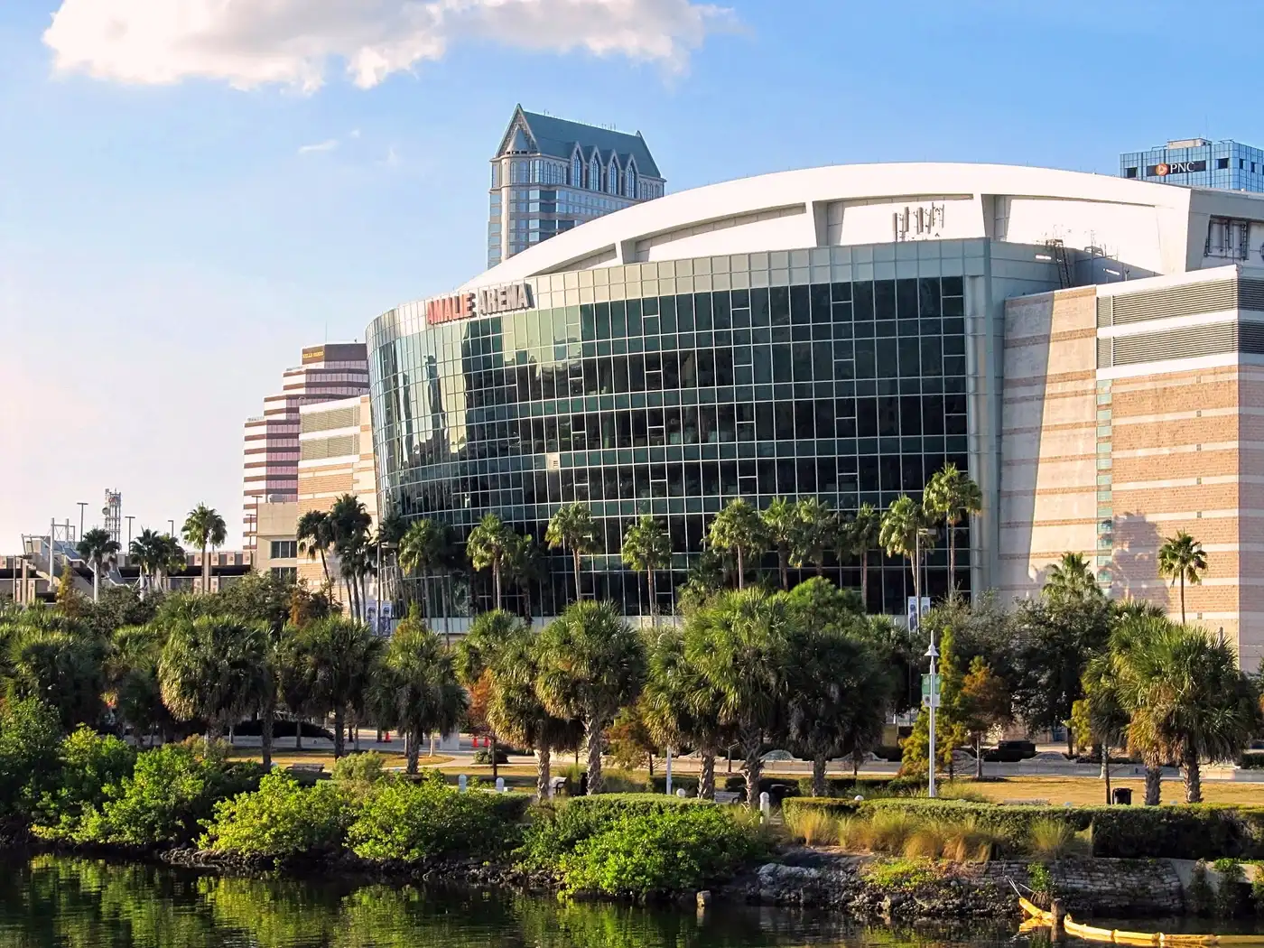 The Lightning's downtown Tampa arena on the waterfront, still signed Amalie Arena, with palm trees along the water