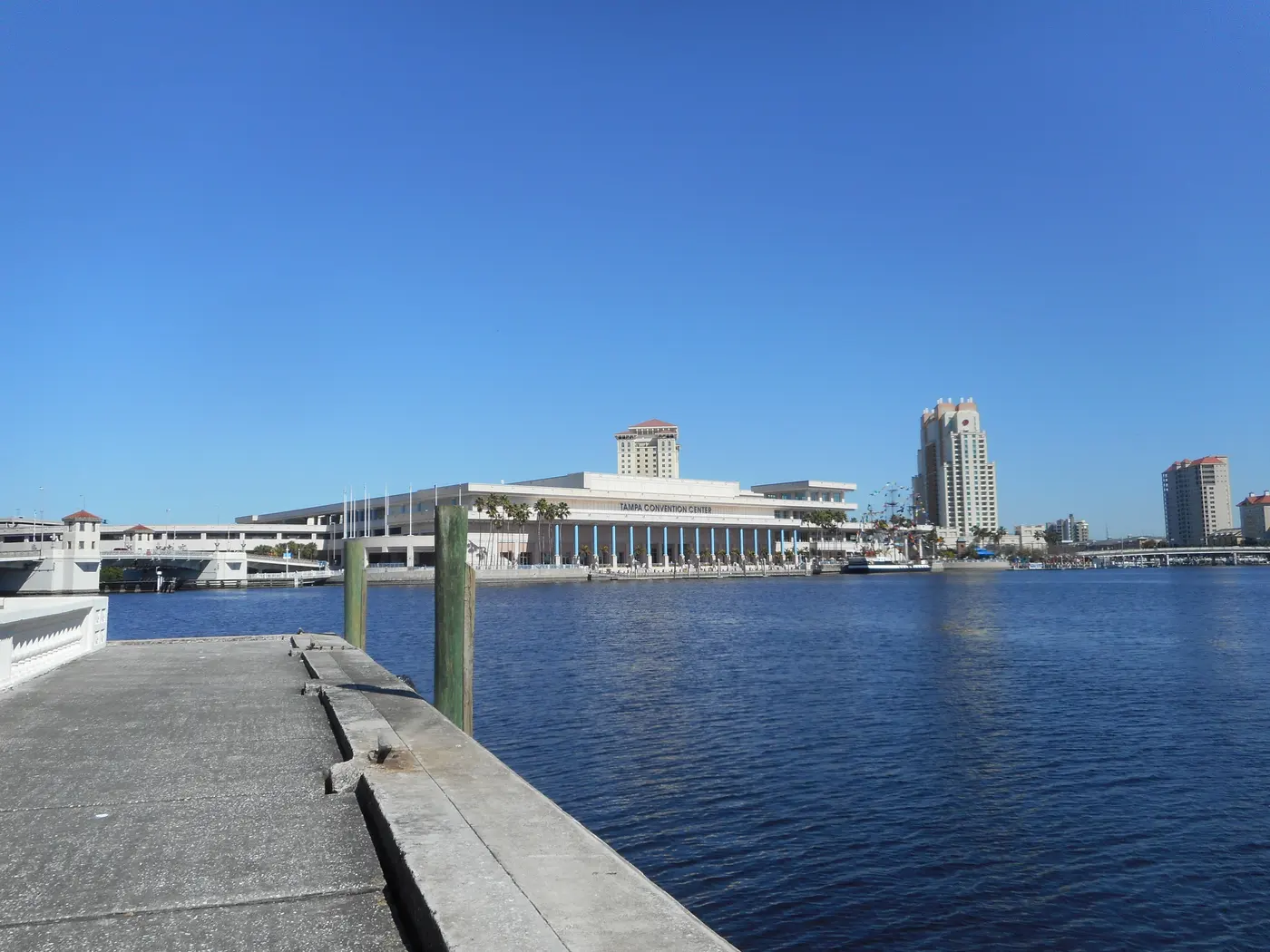 A view along the Bayshore Boulevard waterfront in Tampa, with a fishing pier, Hillsborough Bay and the Tampa Convention Center in the distance