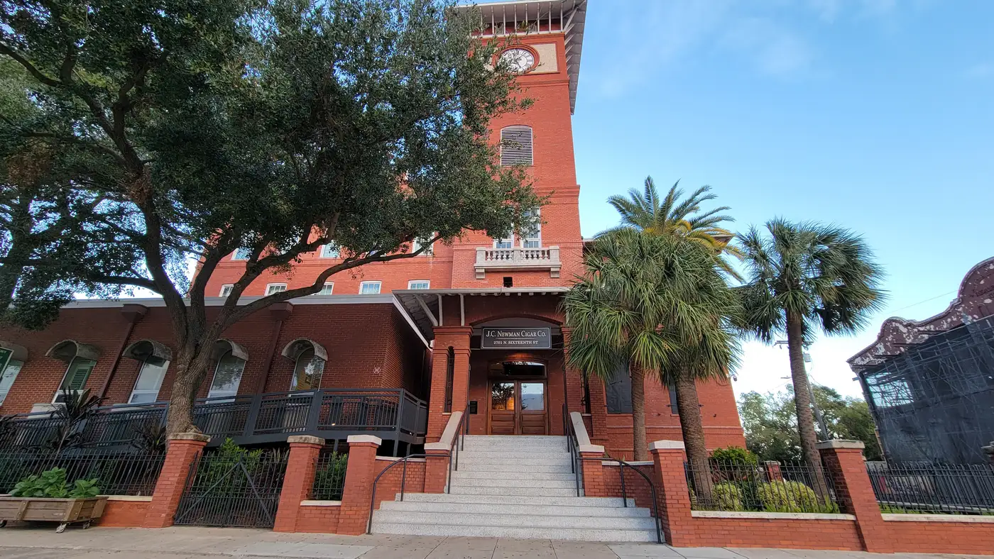 The red-brick J.C. Newman Cigar Co. El Reloj factory building with its clock tower and columned entrance steps