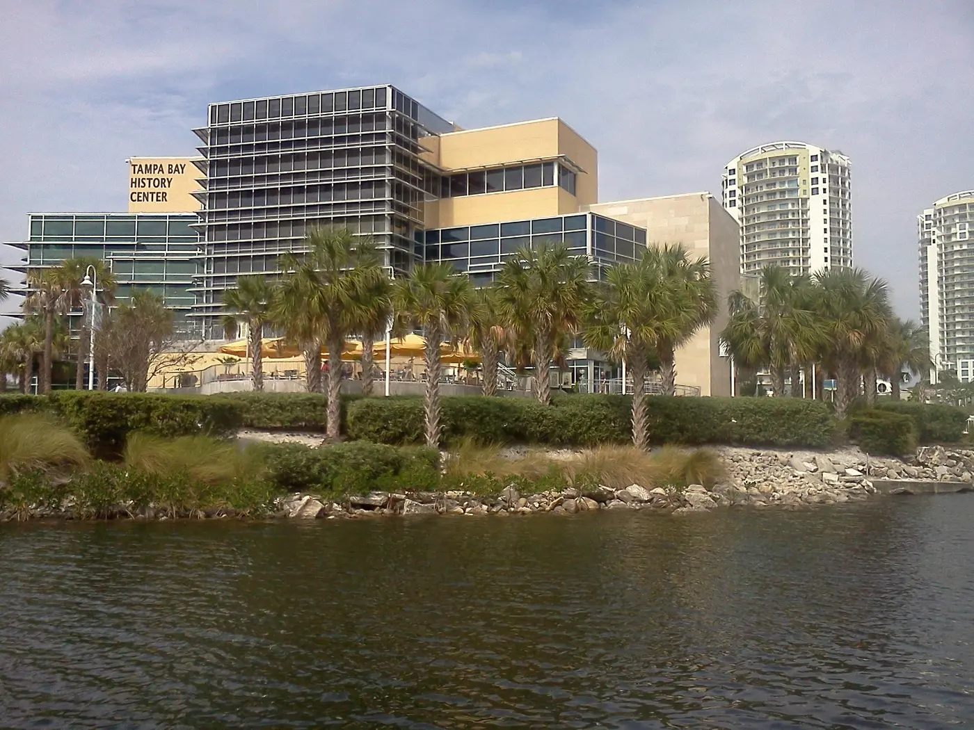 The Tampa Bay History Center's waterfront building, with its name in large letters, seen across the Hillsborough River