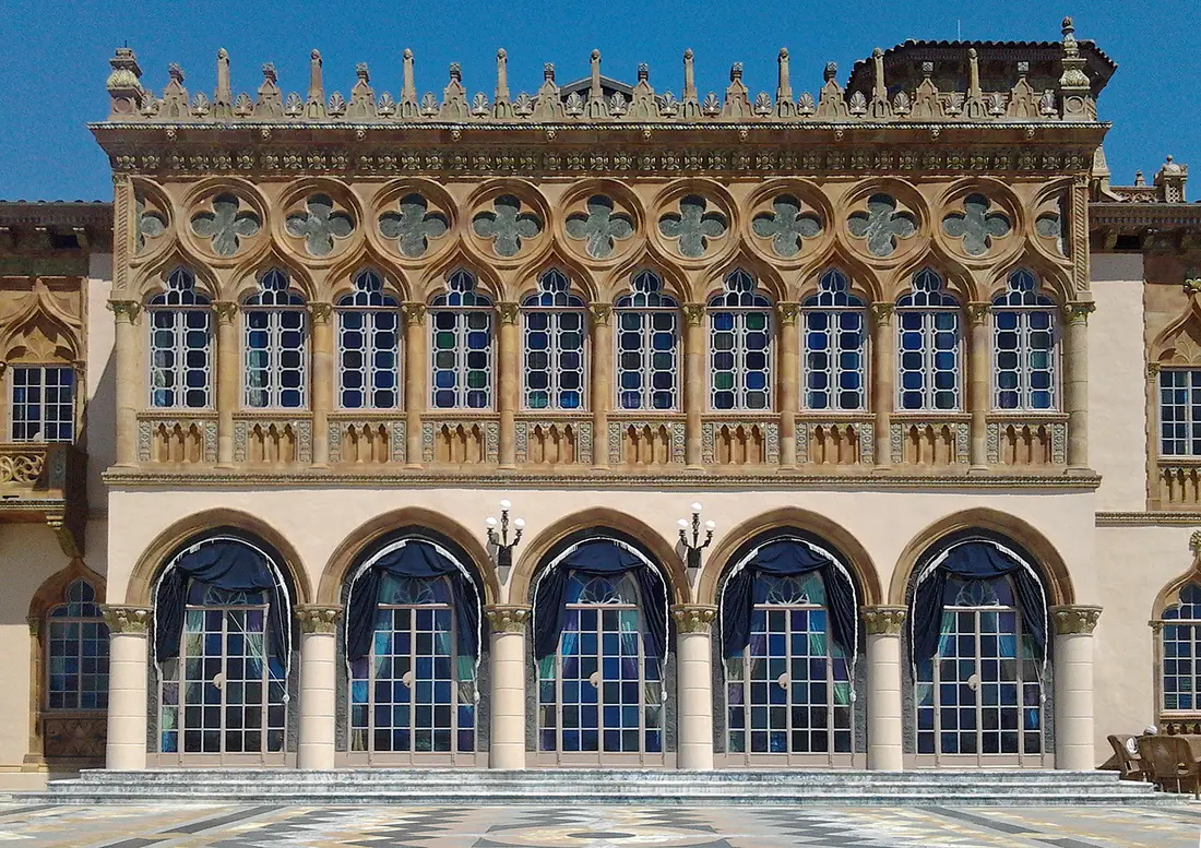 The Venetian Gothic bayside facade of Ca' d'Zan, with stained-glass arcade windows and a colonnaded loggia, on the Ringling estate in Sarasota