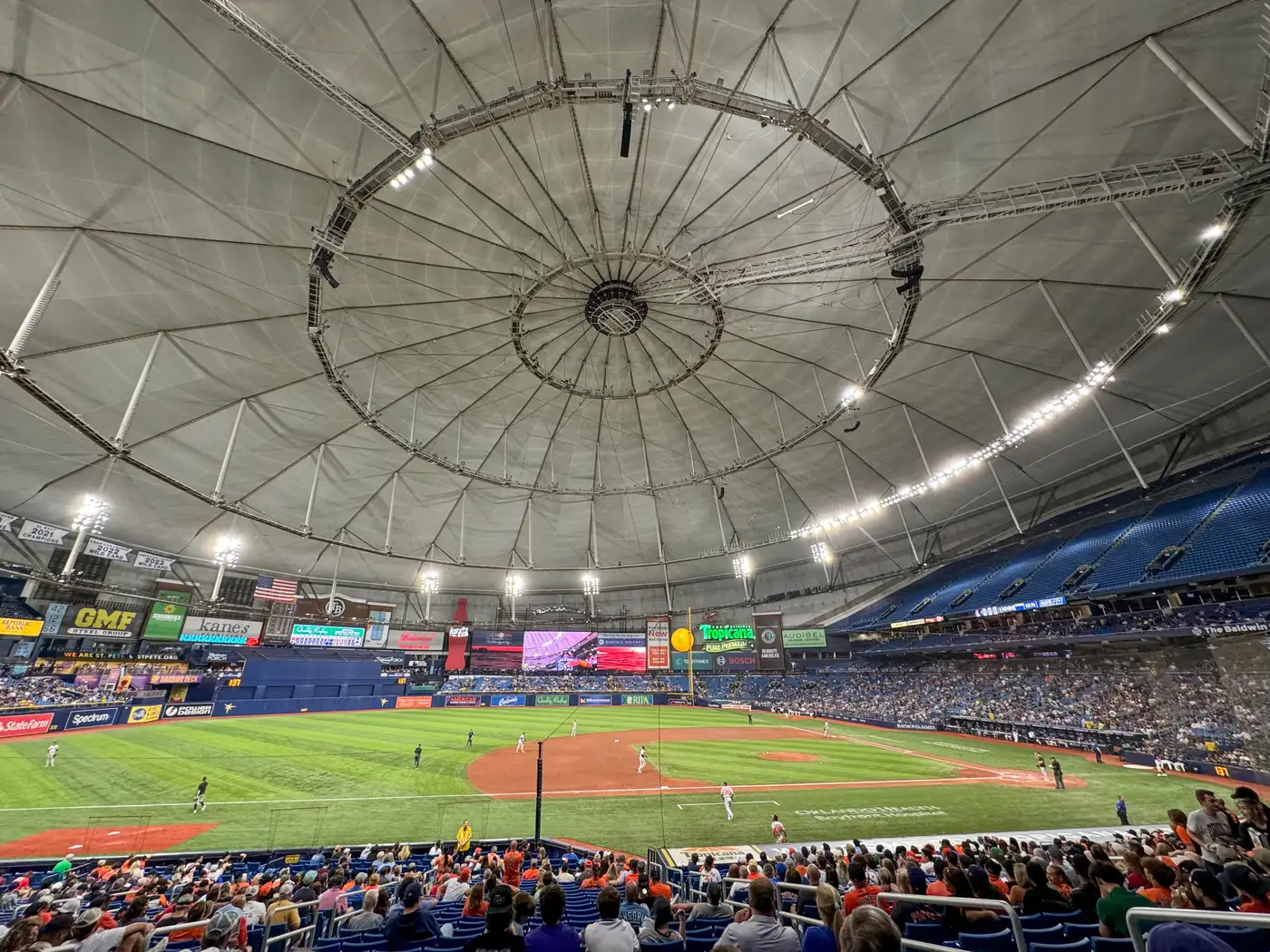 The interior of Tropicana Field's domed roof during a baseball game, with the infield and stands visible