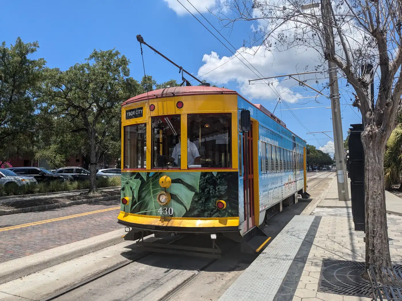 TECO Line Streetcar No. 430, painted blue and yellow, stopped on the tracks in Ybor City