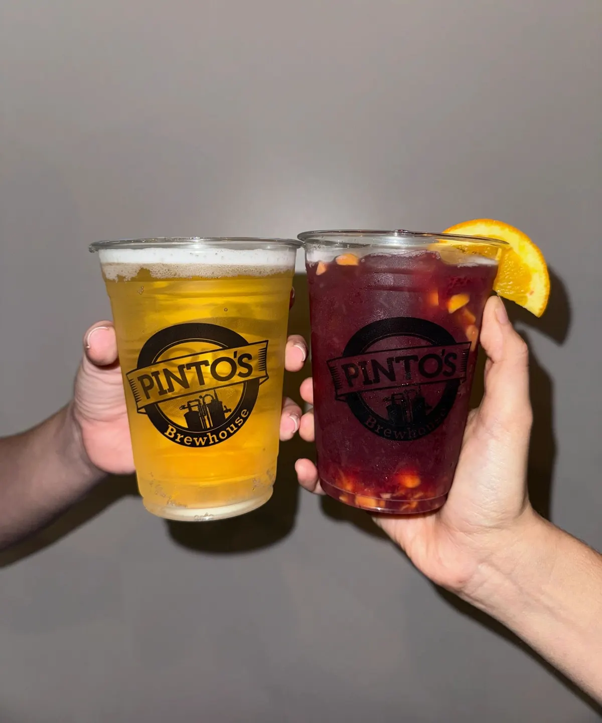 Two Pinto's Brewhouse cups toasting