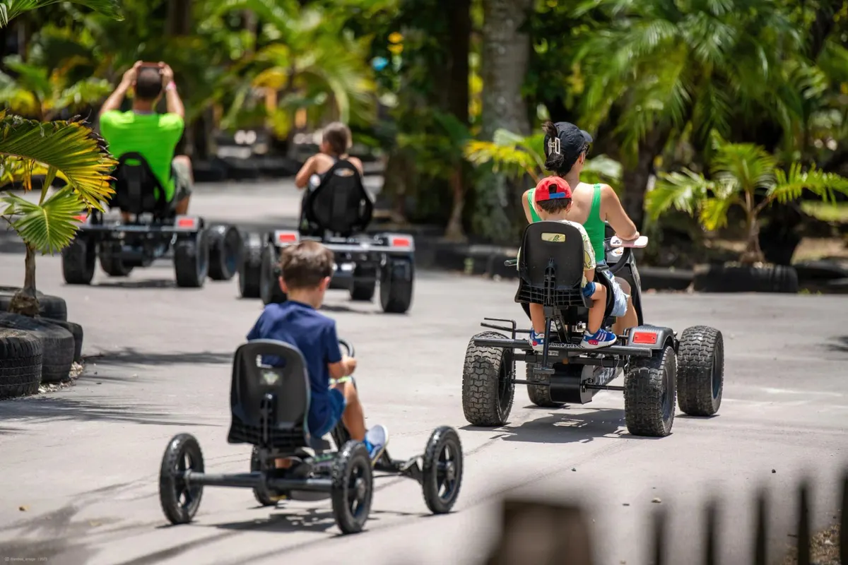 Kids riding pedal go-karts on Pinto's Farm race track