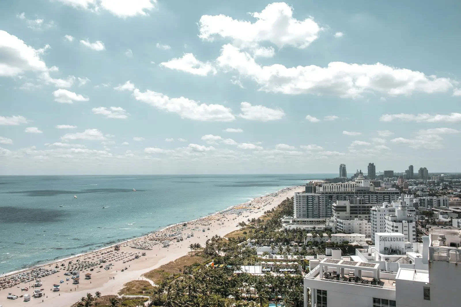 Aerial view of Miami Beach hotels, sand, and turquoise ocean