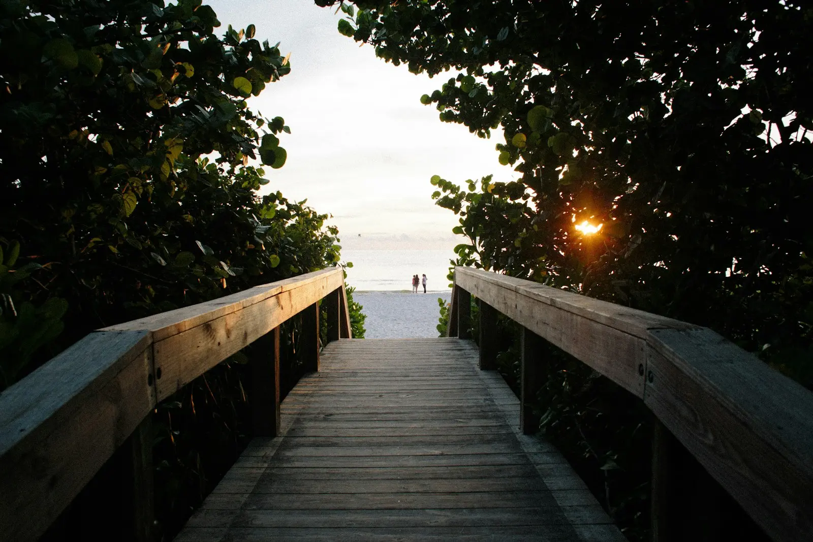 Wooden beach access walkway at sunset in Naples, Florida