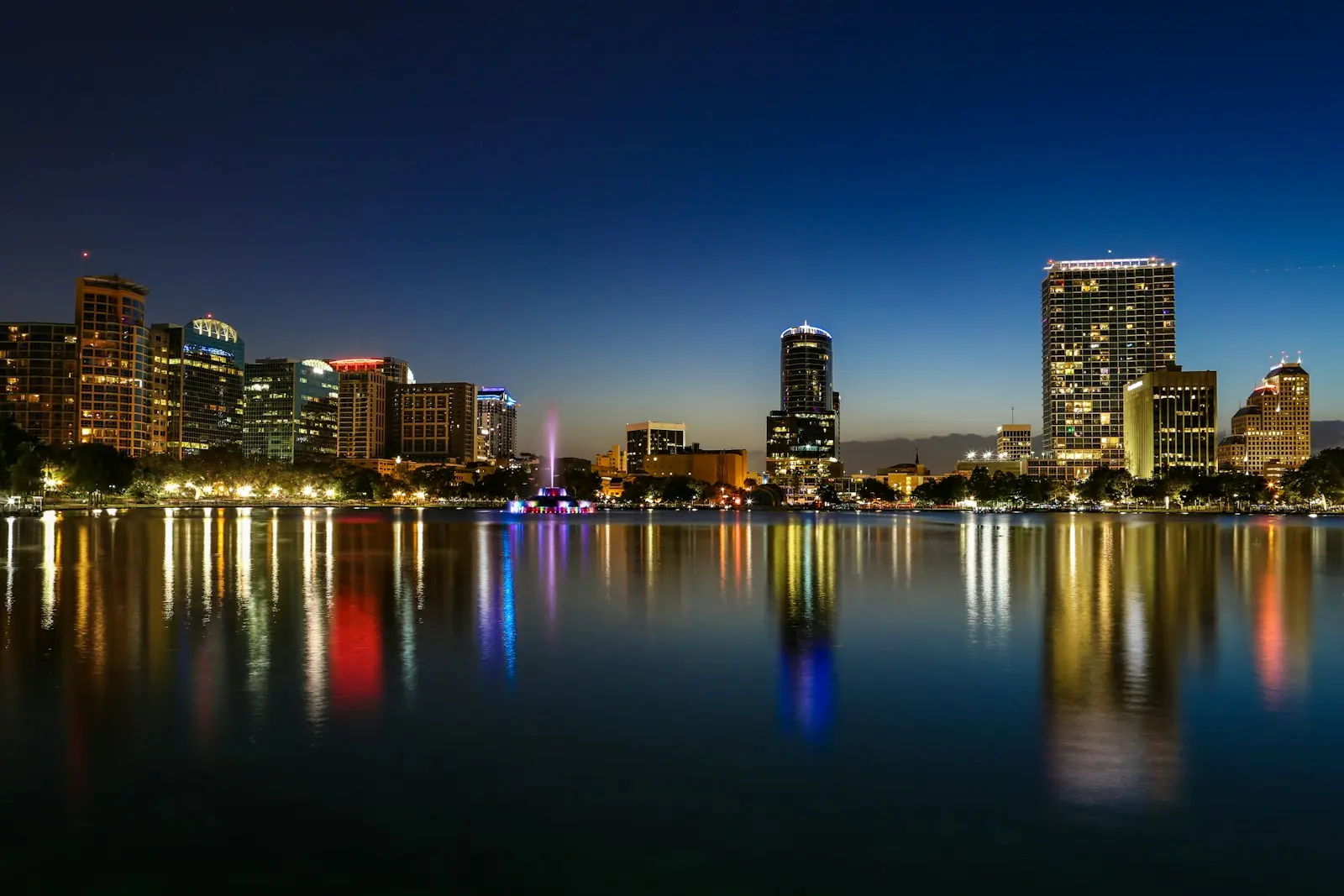 Downtown Orlando lights reflected across Lake Eola at night
