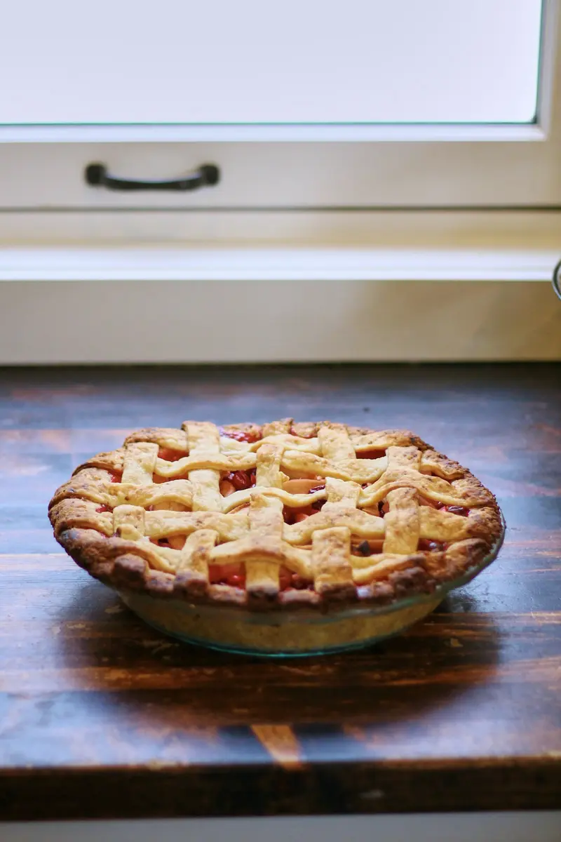 Lattice-top fruit pie on a rustic wooden table